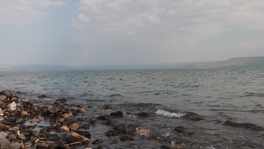 Video of beach and water of sea of Galilee in Israel. Sacred holy place for christians and jewish pepole. Blue relaxing water.
