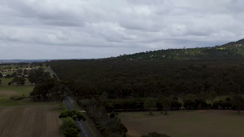 The You Yangs Regional Park is a park in southern central Victoria, Australia. Wide drone shos of the mountins. 