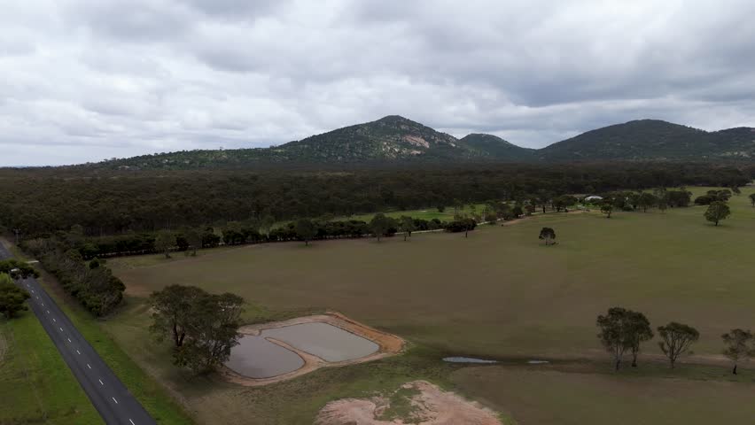 The You Yangs Regional Park is a park in southern central Victoria, Australia. Wide drone shos of the mountins. 