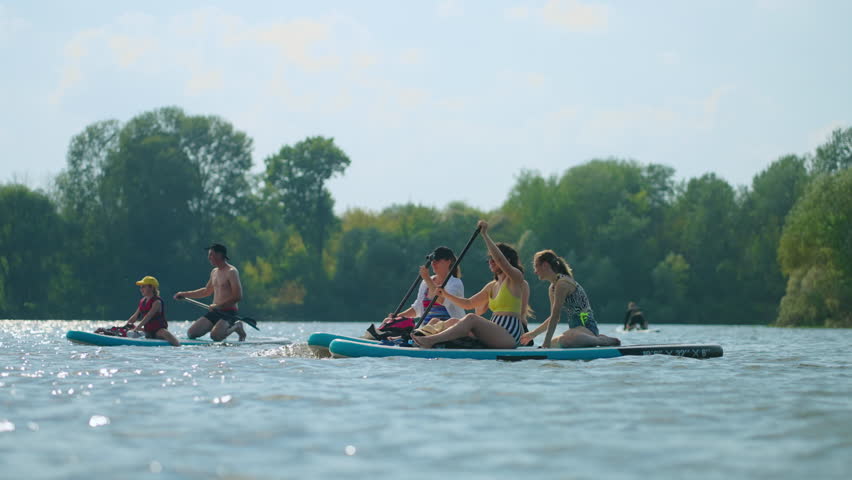 Paddle Board Trip In Summertime, Group Of Athletic People Floating By Inflatable Boards On River Royalty-Free Stock Footage #3406906559