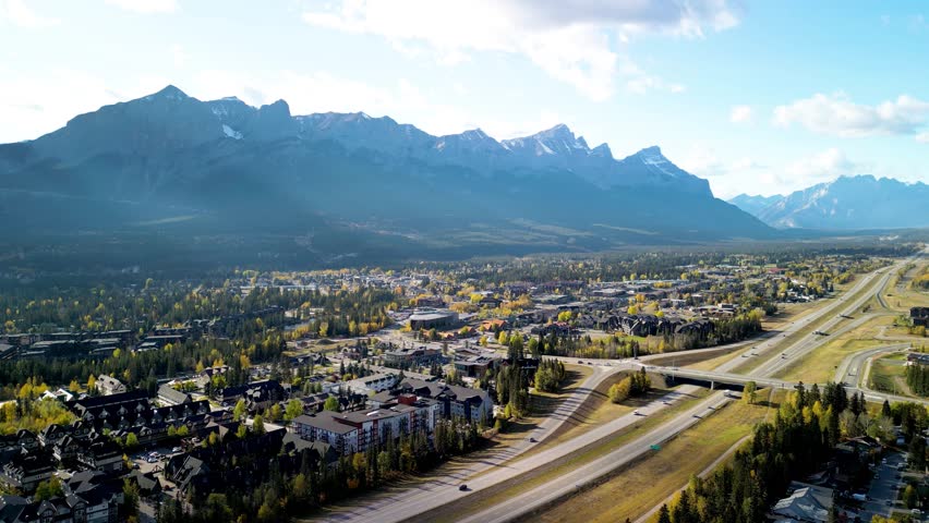 Aerial view of Trans-Canada Highway (Highway 1) exit 89 to Downtown Canmore in Canadian Rockies in a autumn sunny day. Alberta, Canada. Transportation concept.