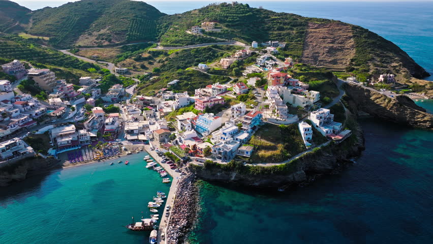 Aerial view of tourist resort hotels and Livadi Beach in Crete, Greece. Luxury villas by Bali Seaside Village with turquoise crystal clear water on Greek Island.