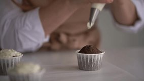 woman prepares cake and pastries. close-up of pastry cream. close-up of muffin. slow motion video. High-quality shooting in 4K format.