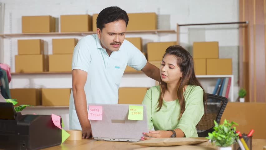 Indian coworkers or couples discussing from laptop while working together at ecommerce warehouse - concept of teamwork, collaboration and business communication Royalty-Free Stock Footage #3407312263