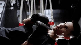 A confident athlete trains for a boxing match. Vertical video for smartphones.
