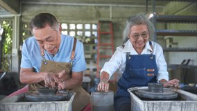 Portrait of a senior Asian couple doing activities together in the pottery workshop. - Powered by Shutterstock - Get 15% off with code: PIKWIZARD15
