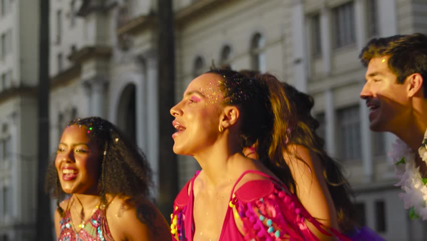 Carnival Celebration: Friends Dancing in the Streets During Festive Brazilian Party, Colorful Costumes and Joyful Expressions in Urban Brazil. Royalty-Free Stock Footage #3407361013