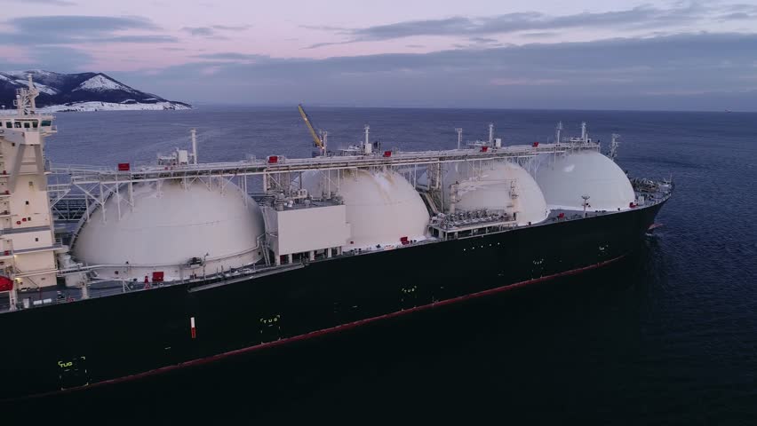 Aerial of Liquified Natural Gas LNG carrier moored to a small gas terminal. Fuel crisis. Sanctions