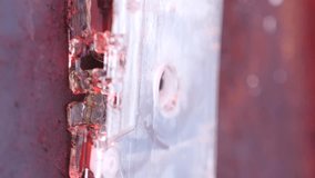 vertical video close-up of an old audio cassette tape melting in the fire