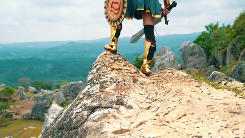 a female warrior holding a sword and golden shield standing on a cliff very bravely in the daytime