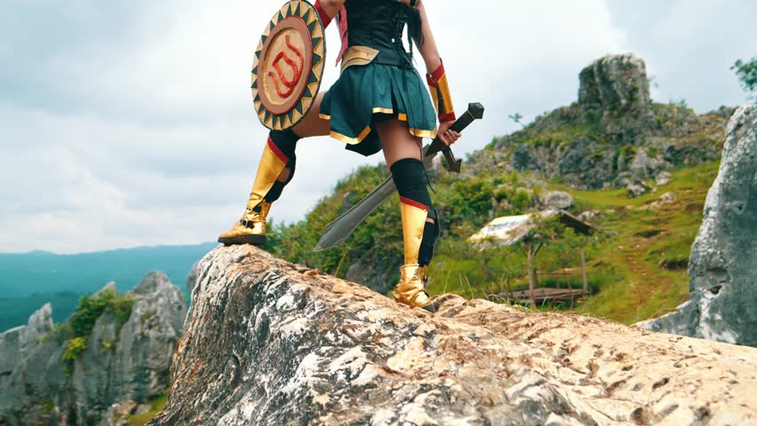 a female warrior holding a sword and golden shield standing on a cliff very bravely in the daytime