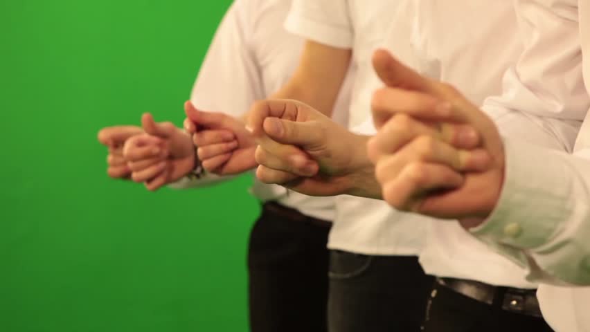 close-up of male hands snapping fingers on green chroma key background
