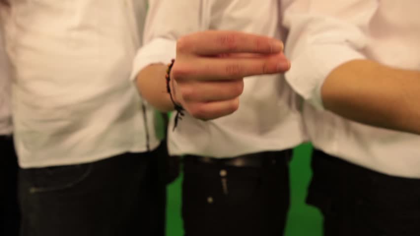 close-up of male hands snapping fingers on green chroma key background