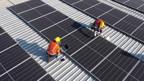 Aerial top view of Engineering technician is a professional trained in skills and techniques installing solar photovoltaic panels system on power industrial factory roof, Engineering concepts. - Powered by Shutterstock - Get 15% off with code: PIKWIZARD15
