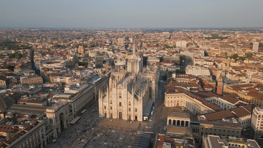 Establishing Aerial Drone Of Milan Cathedral Piazza Del Duomo Di Milano And Distant Milan Skyline At Sunset
