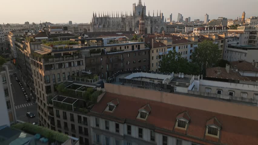 Establishing Aerial Drone Reveal Shot Of Milan Cathedral Piazza Del Duomo Di Milano And Distant Milan Skyline At Sunset Royalty-Free Stock Footage #3407873261
