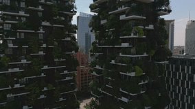 Aerial close up view of ecological modern architecture skyscrapers with green trees on every balcony. Bosco Verticale residential towers in Milan, Italy. 4k Milan city skyscrapers - Powered by Shutterstock - Get 15% off with code: PIKWIZARD15