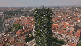 Aerial close up view of ecological modern architecture skyscrapers with green trees on every balcony. Bosco Verticale residential towers in Milan, Italy. 4k Milan city skyscrapers - Powered by Shutterstock - Get 15% off with code: PIKWIZARD15