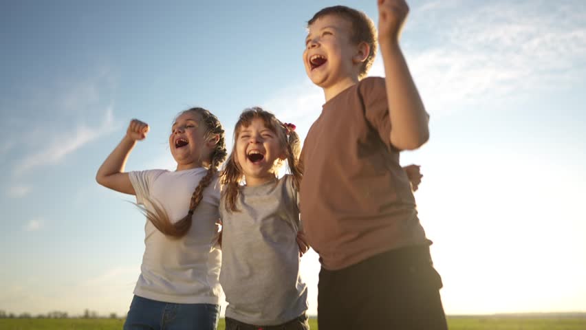 group of kids team hugging a jumping and rejoicing outdoors. happy family teamwork kid dream concept. family children sisters brothers lifestyle have fun hugging in the park in nature Royalty-Free Stock Footage #3407896715