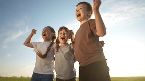 group of kids team hugging a jumping and rejoicing outdoors. happy family teamwork kid dream concept. family children sisters brothers lifestyle have fun hugging in the park in nature - Powered by Shutterstock - Get 15% off with code: PIKWIZARD15