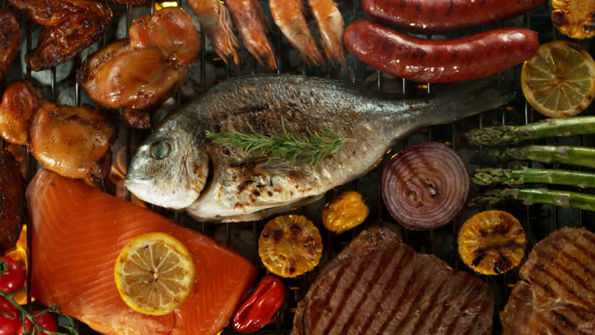 Super slow motion of mix of meats, fish and vegetable on grill grid. Filmed on high speed camera, 1000 fps