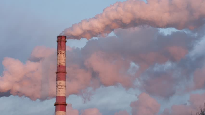 Smoke plume from high stack against blue skyline.