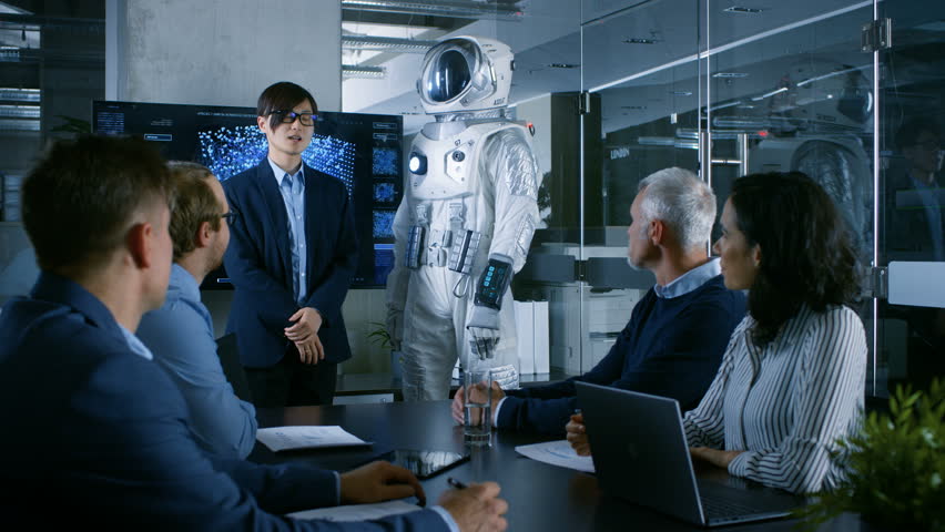 In the Conference Room Chief Engineer Presents Next Generation Space Suit to a Board of Directors. Completely Original Design with Integrated AI and Neural Network Systems. New Level of Space Travel. | Shutterstock HD Video #34079923