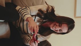 Vertical video, Girl celebrating her win at video game, while her boyfriend is upset about losing