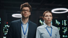IT administrators couple working in network data storage server room closeup. Serious technicians man woman looking distance at modular datacenter. Engineers colleagues in operative modern cabinet  - Powered by Shutterstock - Get 15% off with code: PIKWIZARD15