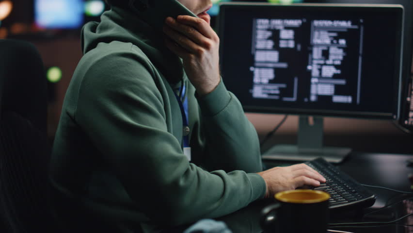 IT man talking cellphone coding computer at night workplace closeup. System security specialist typing keyboard working at control center. Serious coder guy calling smartphone programming alone  - Powered by Shutterstock - Get 15% off with code: PIKWIZARD15