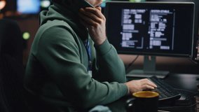 IT man talking cellphone coding computer at night workplace closeup. System security specialist typing keyboard working at control center. Serious coder guy calling smartphone programming alone  - Powered by Shutterstock - Get 15% off with code: PIKWIZARD15