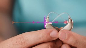 Waveform on Hearing aids in hands making heart shape over blue background with sound simulation bar. Closeup of listening device for people with hearing disorder. Equalizer, wave frequency, sound bar - Powered by Shutterstock - Get 15% off with code: PIKWIZARD15