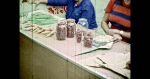 People at spontaneous food market sell rural food, outdoor. Women, grandmothers, saleswomen sell mushrooms. Buyers buy vegetables on summer city street. Vintage color film. Retro archive 1980s Russia 