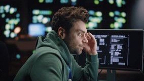 Tired coder working computer at night datacenter closeup. Overworked man wearing glasses staring pc monitors at dark workplace. Fatigued software developer waiting work day ending at late office - Powered by Shutterstock - Get 15% off with code: PIKWIZARD15