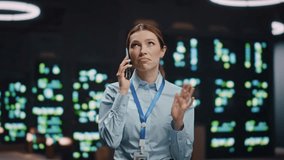 Woman IT specialist calling mobile phone at rack server room closeup. Computer scientist lady talking cellphone call at datacenter. IT engineer talking smartphone looking distance in tech office - Powered by Shutterstock - Get 15% off with code: PIKWIZARD15