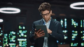 Serious IT specialist working tablet computer in data center closeup. Successful businessman overlooking server farm cloud computing facility typing digital device screen. Man looking asides at work - Powered by Shutterstock - Get 15% off with code: PIKWIZARD15