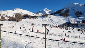 Beautiful panoramic aerial drone view of Sestriere village from above, famous ski resort in italian western Alps. Skiing in slopes. Piedmont, Italy. 