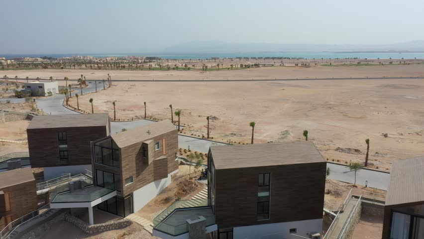 Aerial Drone Shot Of Contructed housing units lending in the to the vast desert