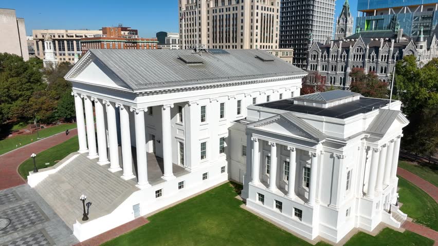 Virginia capitol building. Aerial orbit around prestigious white-pillar government state house. Downtown Richmond, VA. Royalty-Free Stock Footage #3408206517