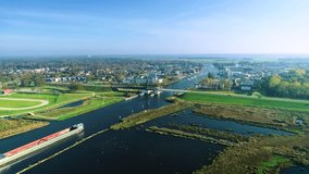 Two Inland Cargo Ships Approaching a Bridge - Friesland, The Netherlands 4K Drone Footage
