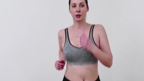 Young woman exercises and keeps fit on a treadmill at home, Video Clip 4K
