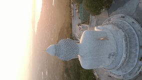 Vertical video. Aerial view of Big Buddha statue at sunrise in Phuket, Thailand.