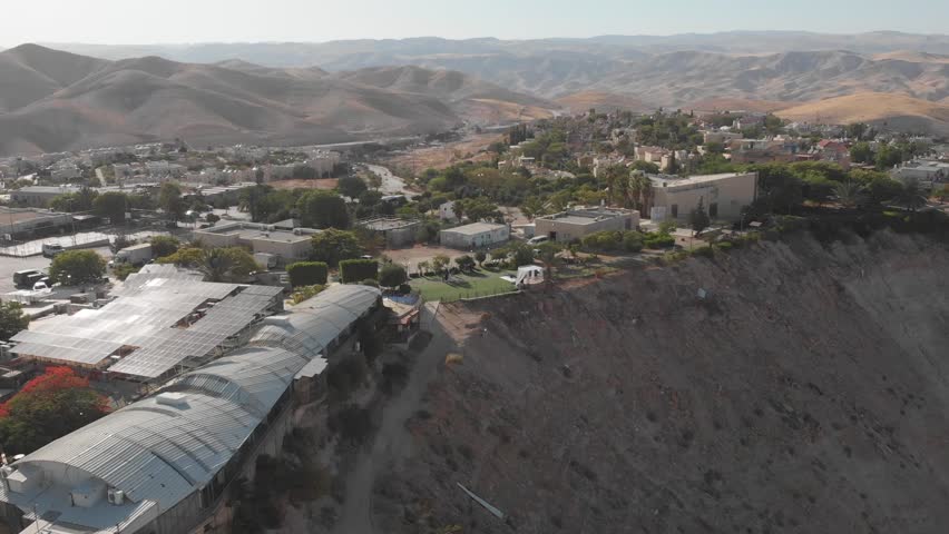 A Jewish wedding chuppah stands on a cliff. Kibbutz on the edge of the desert.