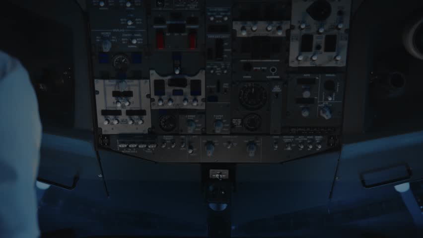 Hand of Airplane Pilot Using Control Panel in Plane Cockpit Close-Up. Aviator Using Aircraft Technology in Dark Cabin to Flight Study. Man Preparing to Fly Off Airport and Pushing Switches Closeup 4k Royalty-Free Stock Footage #3408567037
