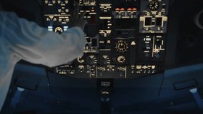 Hand of Airplane Pilot Using Control Panel in Plane Cockpit Close-Up. Aviator Using Aircraft Technology in Dark Cabin to Flight Study. Man Preparing to Fly Off Airport and Pushing Switches Closeup 4k - Powered by Shutterstock - Get 15% off with code: PIKWIZARD15