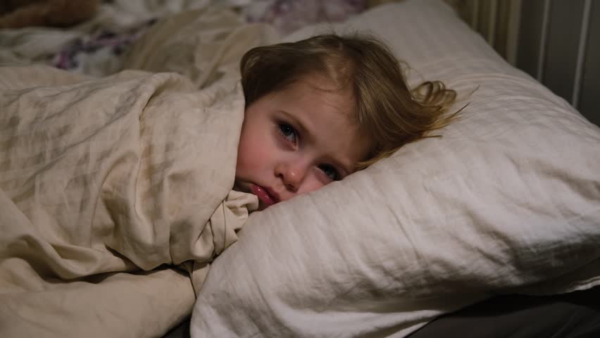 Child Falls Asleep. Peaceful Adorable Baby Sleeping at Home. Slumbering Little Toddler. Two Years Old Girl Sleeps. Nursery Room Interior Background. Serene Dream. Cute Face Close Up. Deep Kid Slumber