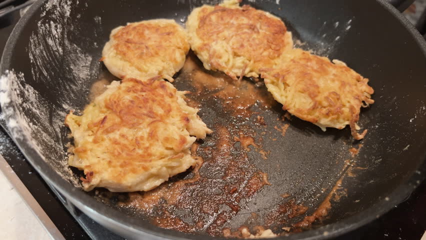 Cooking at home. Delicious crispy hash browns. Potato flapjack cooked on frying pan with oil. Film grain pixel texture. Soft focus. Blur. Live camera Royalty-Free Stock Footage #3408625075