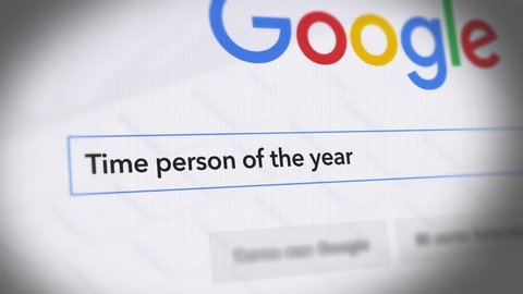 USA-Popular searches in 2017 Google Search Engine - Search For Time person of the year Monitor with reflection hands typing a search on google