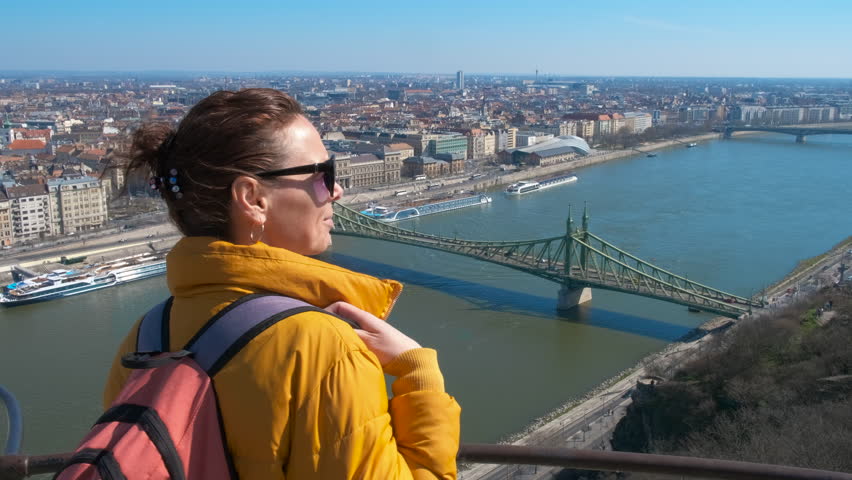 Female enjoy hungarian capital. A view of female enjoy the landscape of Budapest on observation deck.