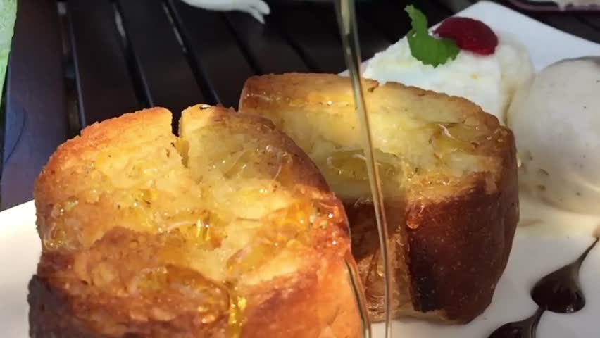 Sweet honey on top of the bread.Close-up of a delicious dessert in restaurant.